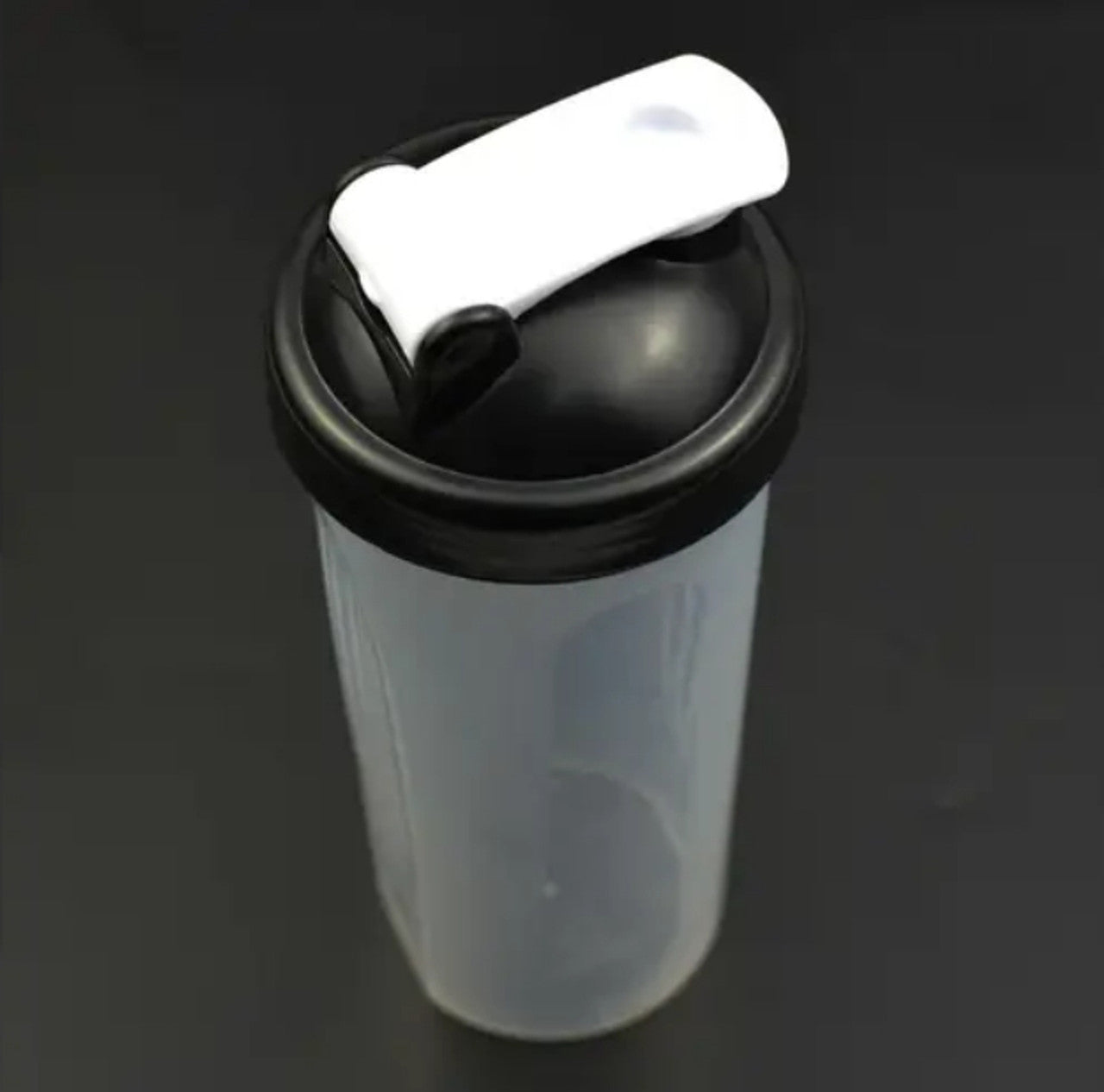 600ml Shaker Bottle with Stainless Steel Whisk Ball with black lid and white handle on a dark background