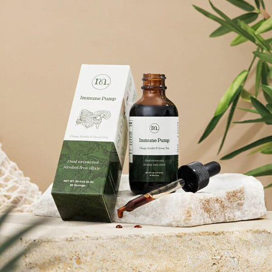 Bottle and packaging of 'Immune Pump' on a natural stone surface with a plant in the background.