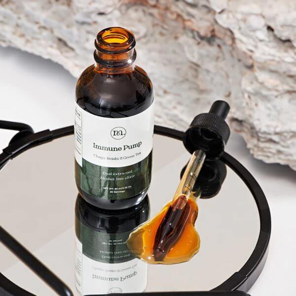 Bottle of 'Immune Pump' with a dropper on a reflective surface