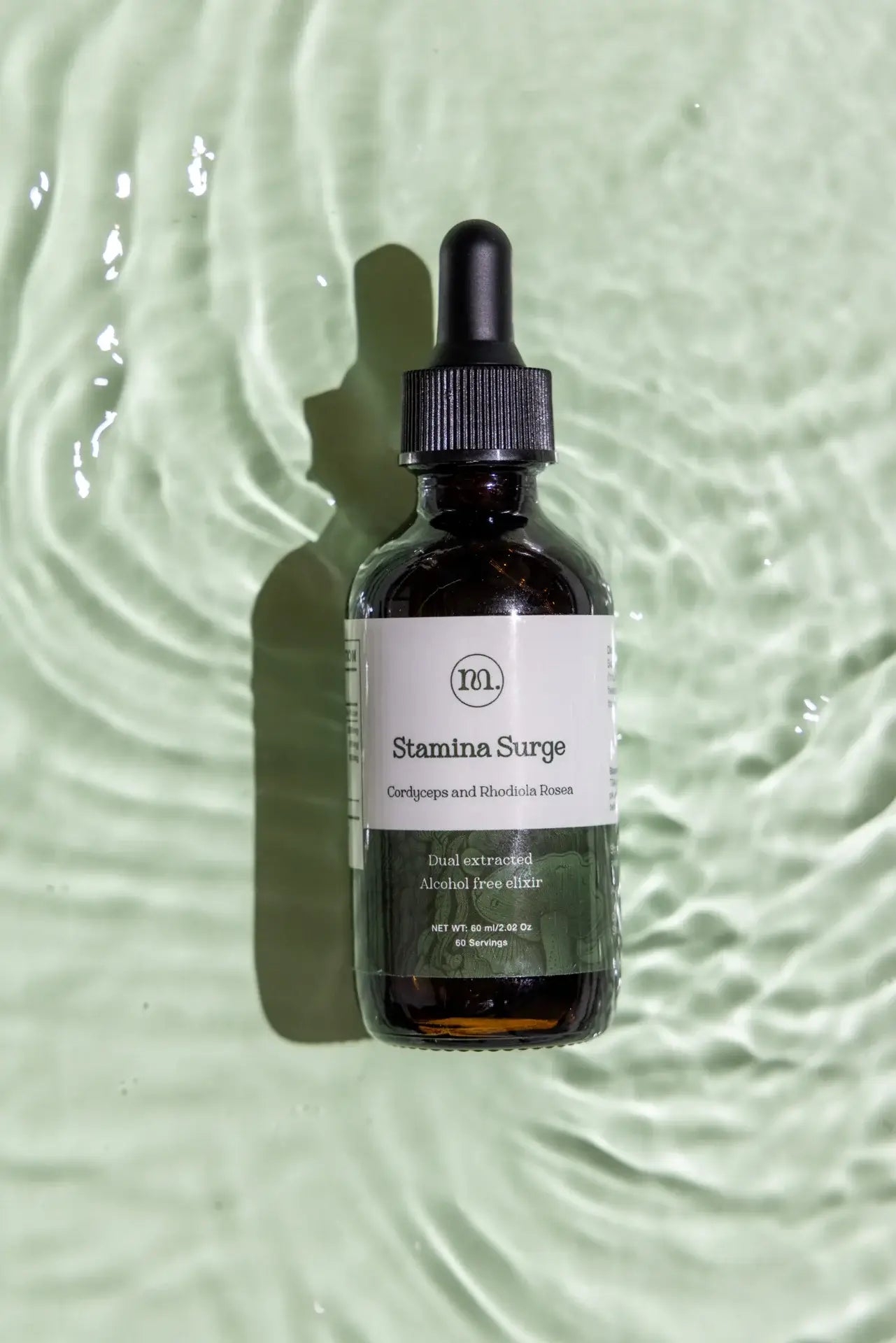 Bottle of Stamina Surge on a textured green background