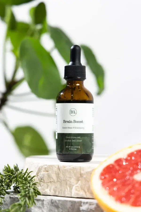 Bottle of 'Brain Boost' supplement with a dropper on a natural background